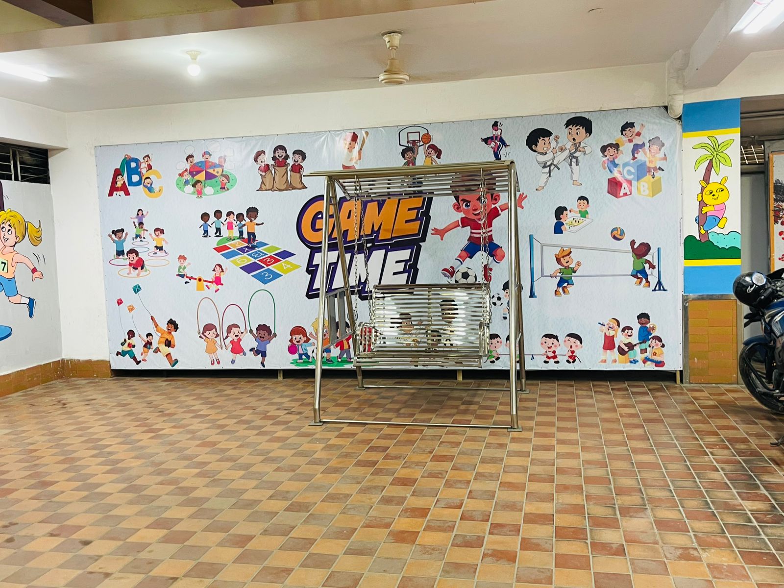 Indoor play and activity zone decorated with colorful wall art at the Uttara section